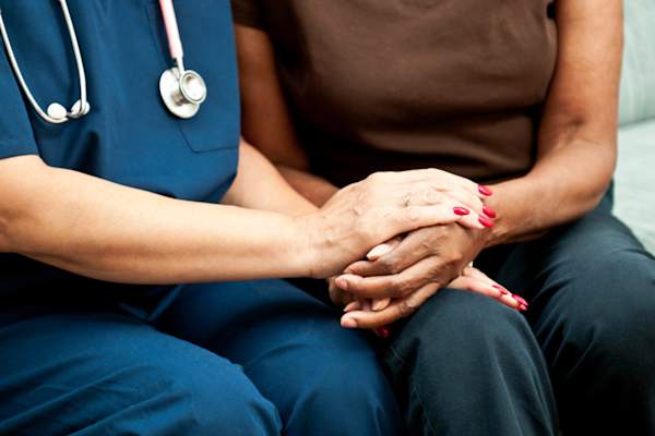 Healthcare Worker's Hands comforting patient