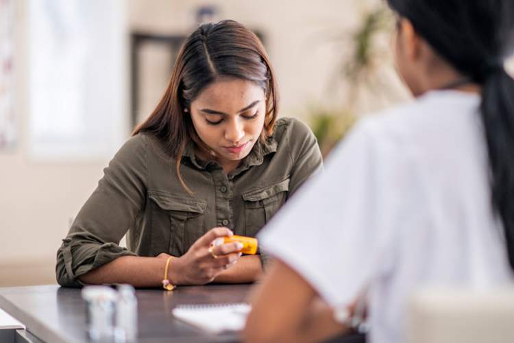 woman with doctor looking at prescription bottle