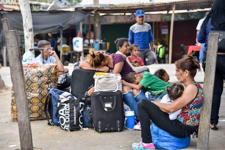 Venezuelans rest after crossing the border between Colombia and Venezuela on June 09, 2019 in Paraguachon, Colombia.