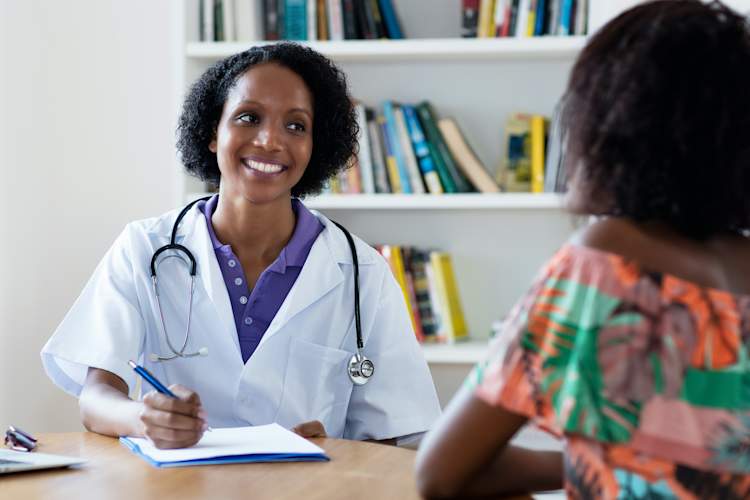 Black woman talking to doctor
