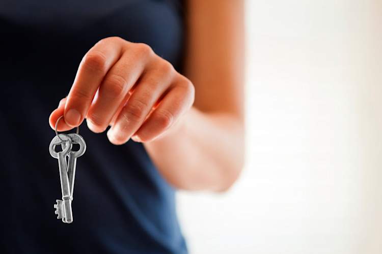 woman's hand dangling keys