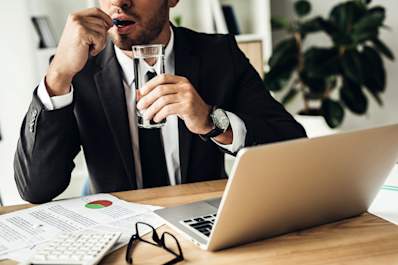 Businessman taking a blue pill