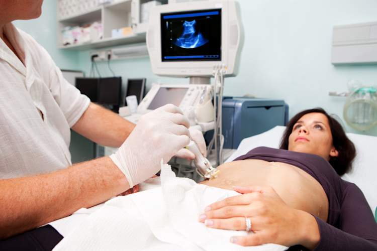 Doctor is performing liver biopsy to women supporting with Ultrasound