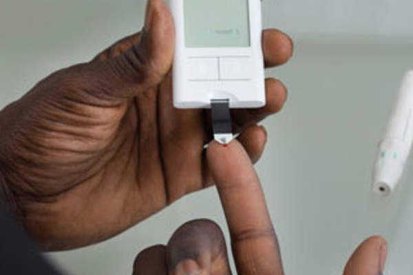 A man's hands and a glucose test
