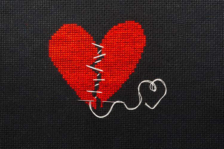 broken heart with zig-zag thread holding it together embroidery
