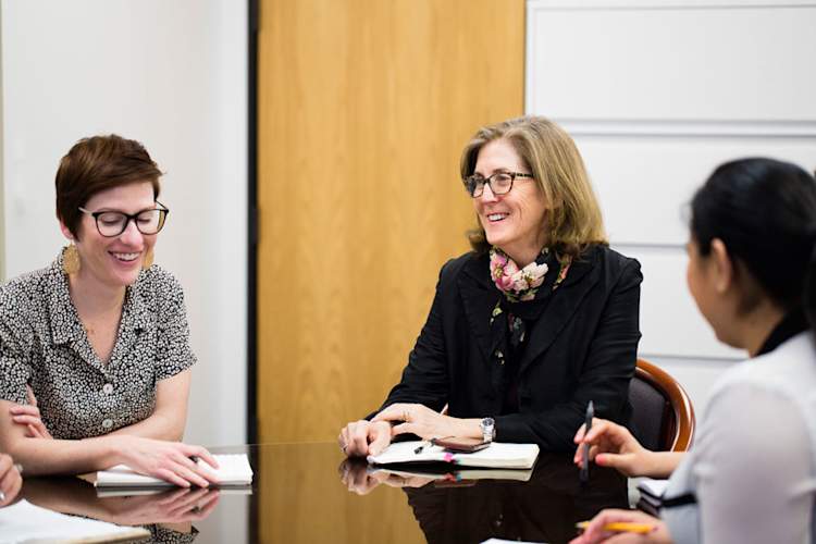 Judith Currier meeting with colleagues