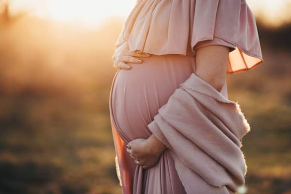 Pregnant woman in a dusty pink dress