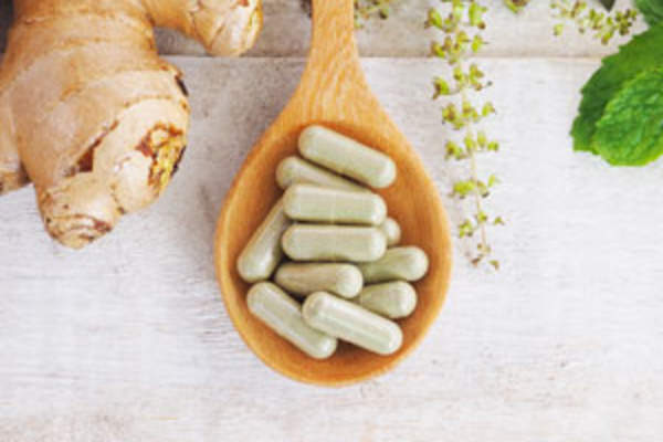 Wooden spoon with food supplement pills