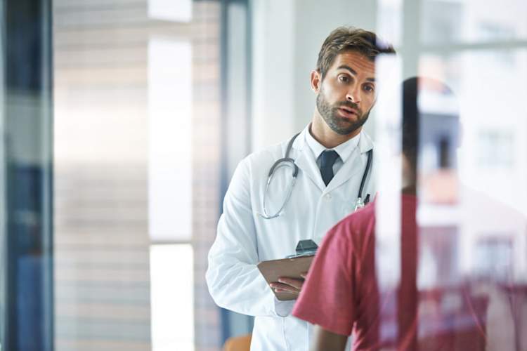 doctor talking to young man