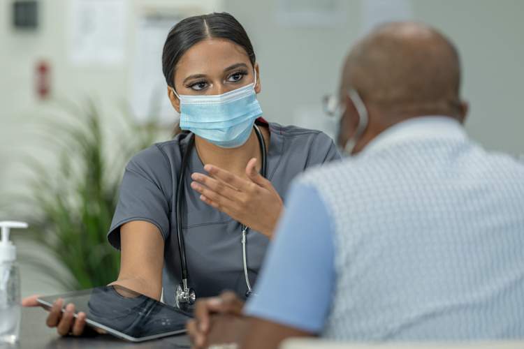 doctor talking to senior patient