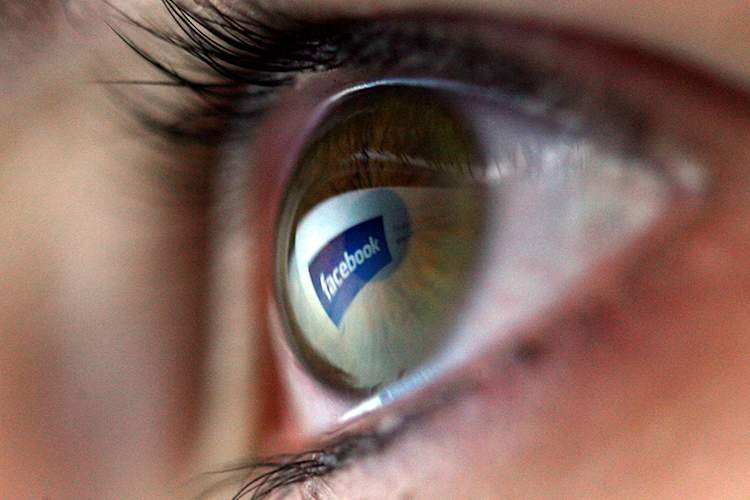 Facebook logo reflected in an eye
