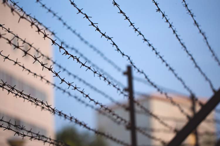 barbed wire in front of prison