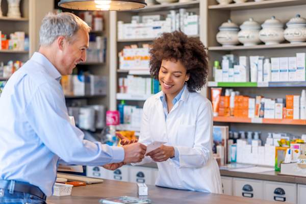 pharmacist helping senior customer