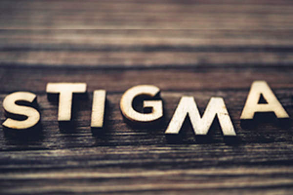 STIGMA in staggered wooden letters on wood background