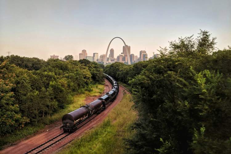 train traveling through Missouri, St. Louis skyline in background