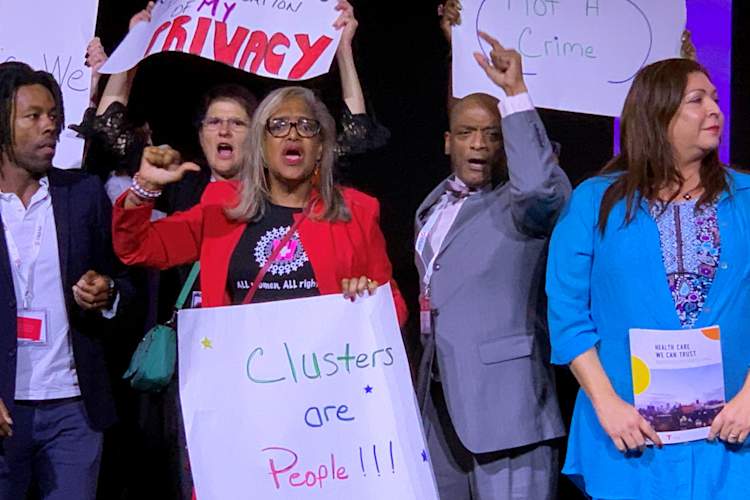 Jaron Benjamin, Lepena Reid, Bryan Jones, and Arianna Lint protest at the U.S. Conference on AIDS (USCA) opening plenary session on Sept. 5