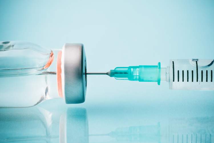 syringe going into vial