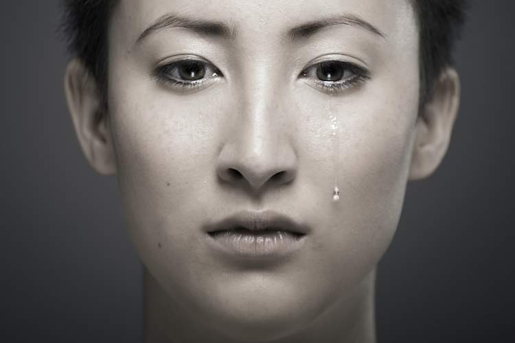 Asian person crying