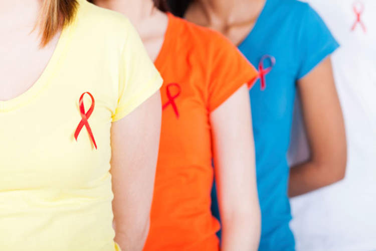 women with red ribbons