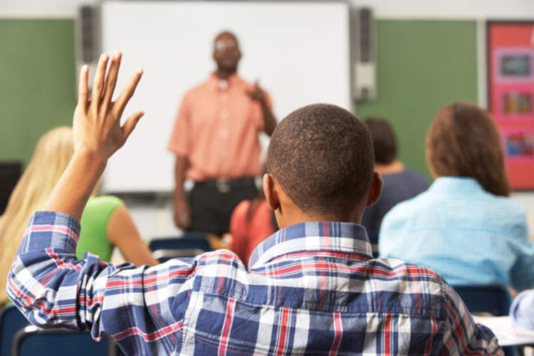 Student raising hand in class