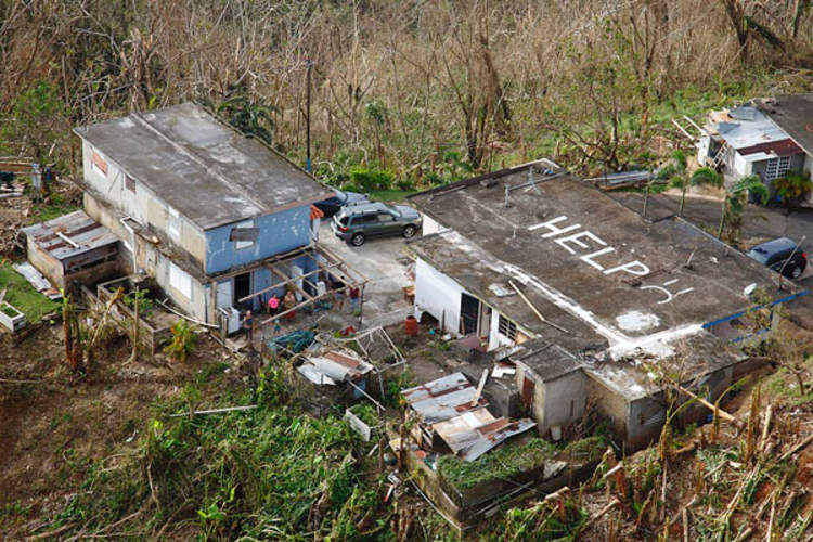 House in Puerto Rico with 'HELP' on written on roof