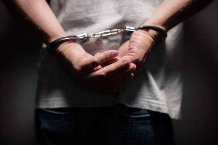 Closeup of hand in handcuffs