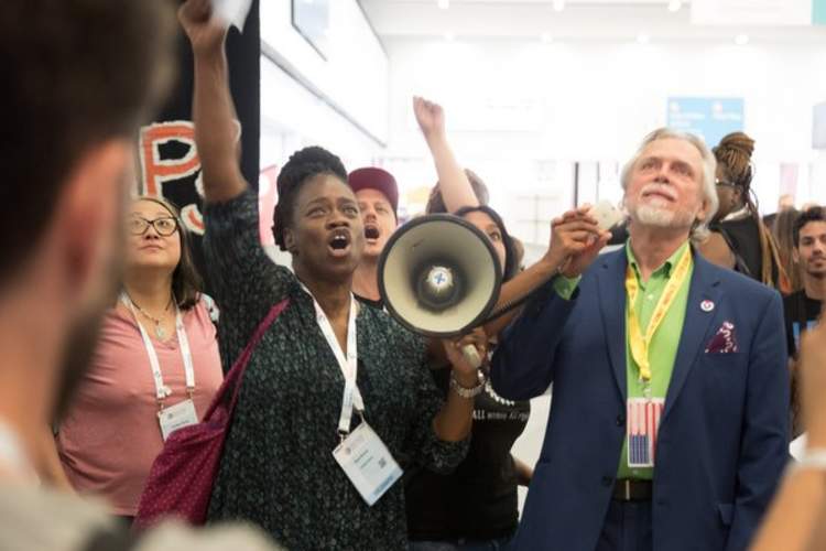 na Brown of the Southern AIDS Coalition (left) and Charles King of Housing Works protest the AIDS 2020 conference location