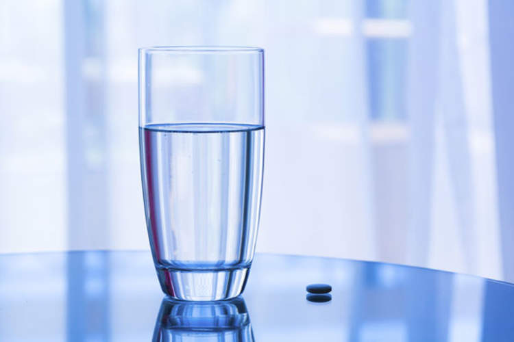 Truvada pill and glass of water