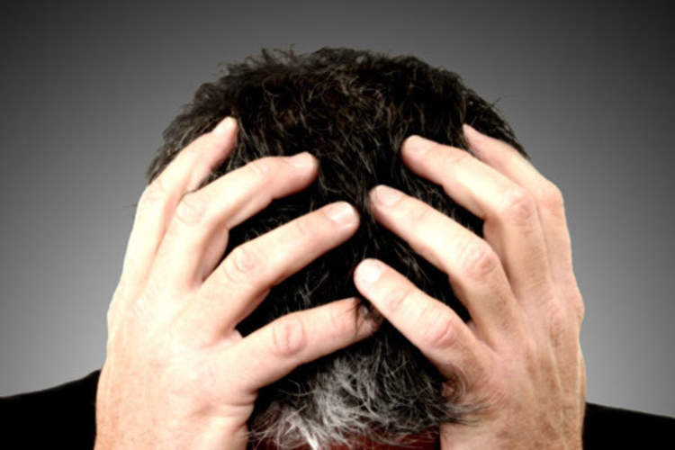 Man holdin his head
