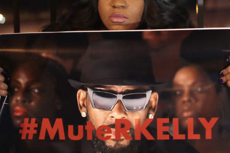 A protestor demonstrates near R. Kelly's studio in Chicago on Jan. 9.
