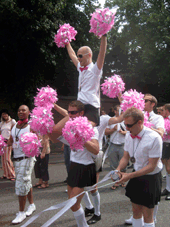 Cheerleaders wave pink pom-poms at Pride.