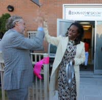 Charles King and Nadine Juste-Beckles 'high-five' at ribbon-cutting ceremony.