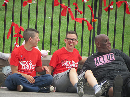 Julie Davids, center, director of national mobilization and advocacy for the AIDS Foundation of Chicago, shares a laugh with her fellow activists while waiting to be arrested.