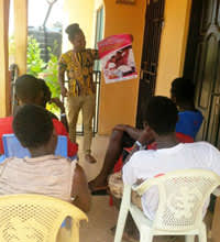 A CEPEHRG peer educator performs outreach about the importance of condom-compatible lube.