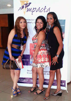 Leyla (far right) and other Peruvian advocates pose in front of an IMPACTA poster.