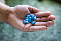 Louis Arevalo holds his Truvada pills at his home in Los Angeles, California on July 17, 2015. The drug Truvada, used to halt HIV infection, has been shown to be over 90 percent effective when used correctly. (Credit: Heidi de Marco/KHN)