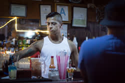 AltaMed is conducting HIV prevention outreach at several Latino gay bars in the Los Angeles area. Latinos make up about 21 percent of new infections nationally, according to the U.S. Centers for Disease Control and Prevention. (Credit: Heidi de Marco/KHN)