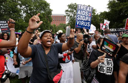 AIDS activists sing and chant during a rally across from the White House in Washington, D.C., July 24 2012, while the International AIDS 2012 conference was under way nearby. (Credit: Kevin Lamarque/Reuters)