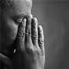 Person with hands over face