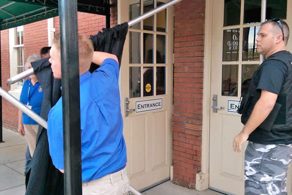 'Charm Ball' security erects a curtain to block the protesting Chase Brexton patients from the view of the gala guests