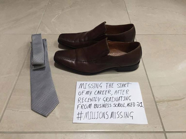 Empty shoes and sign saying 'Missing the start of my career, after recently graduating from business school #MillionsMising'
