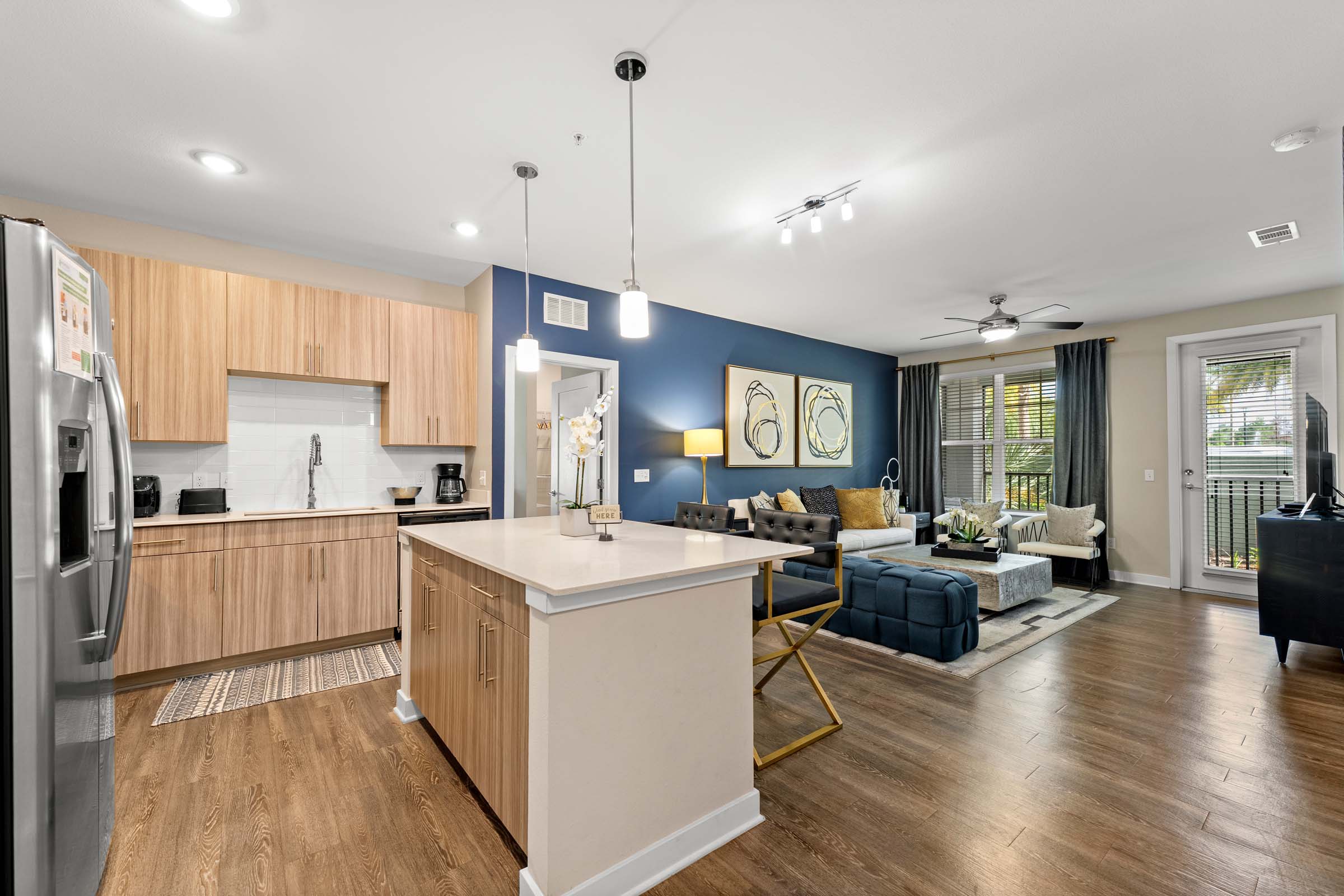 Kitchen and living room in apartment model home at Camden Lake Buena Vista in Orlando, FL.