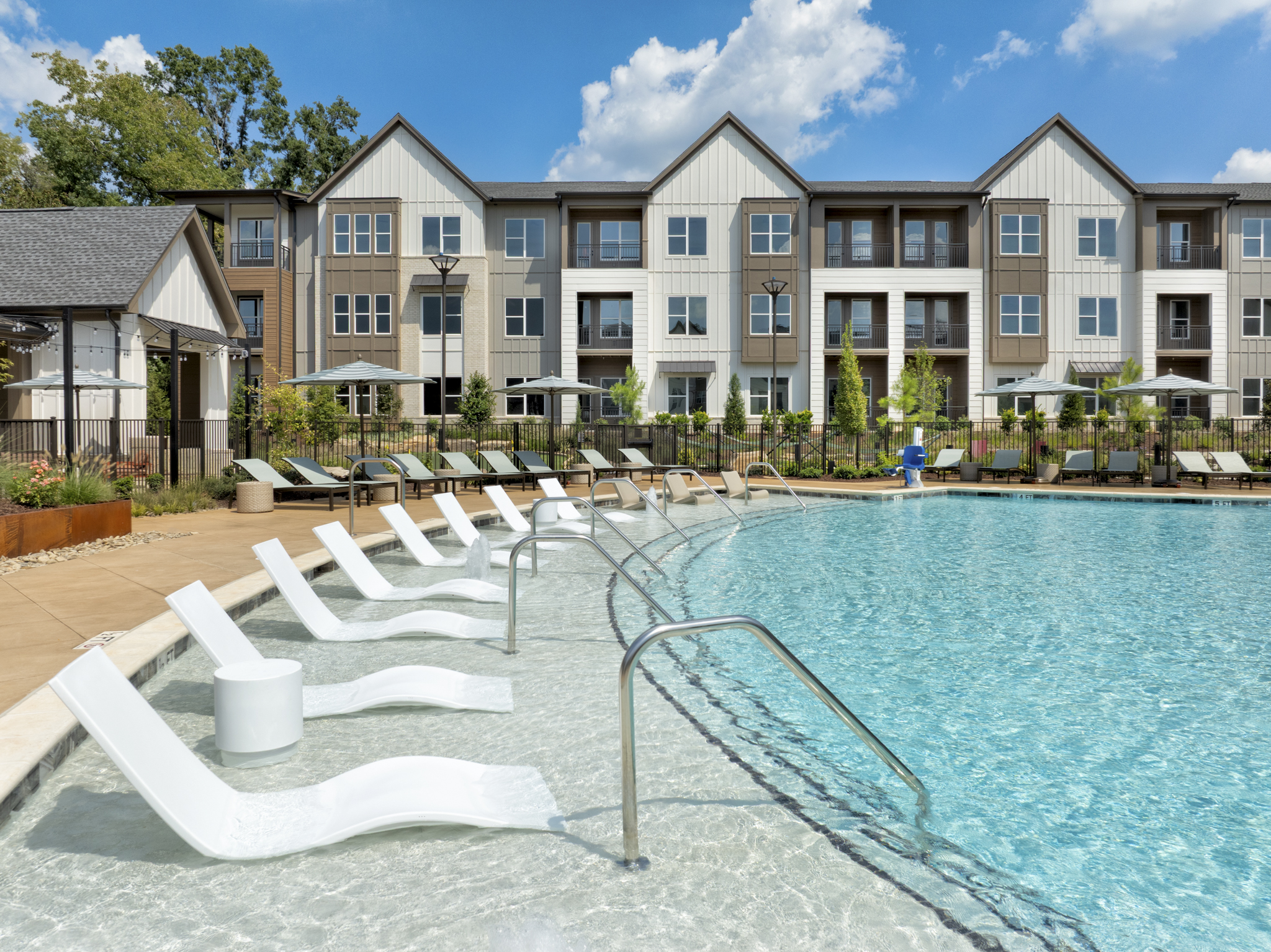 Resort-style pool with in-pool loungers at Camden Blakeney apartments in Charlotte, NC