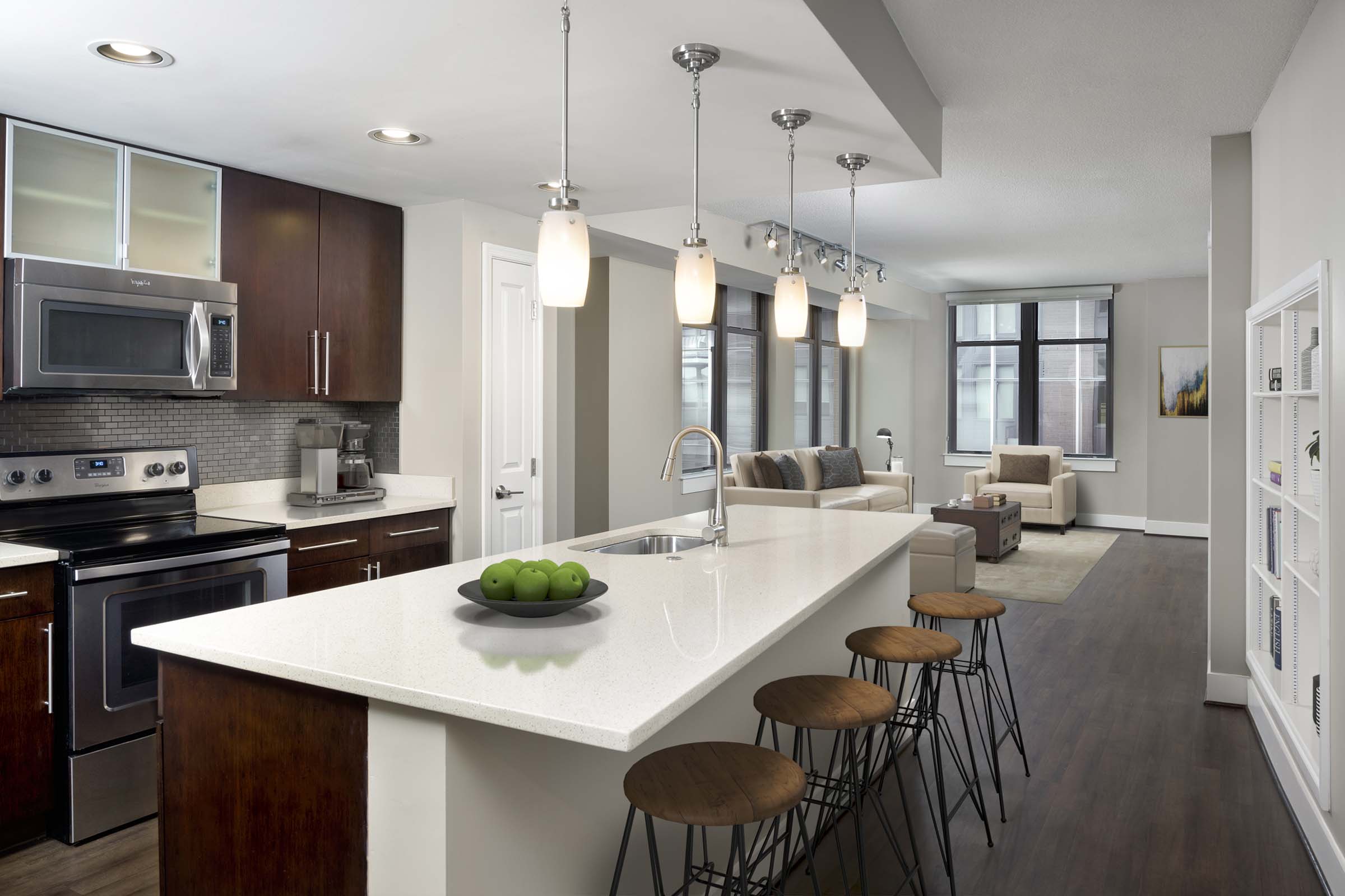 Warm modern style apartment with stainless steel appliances and warm cherry wood cabinets