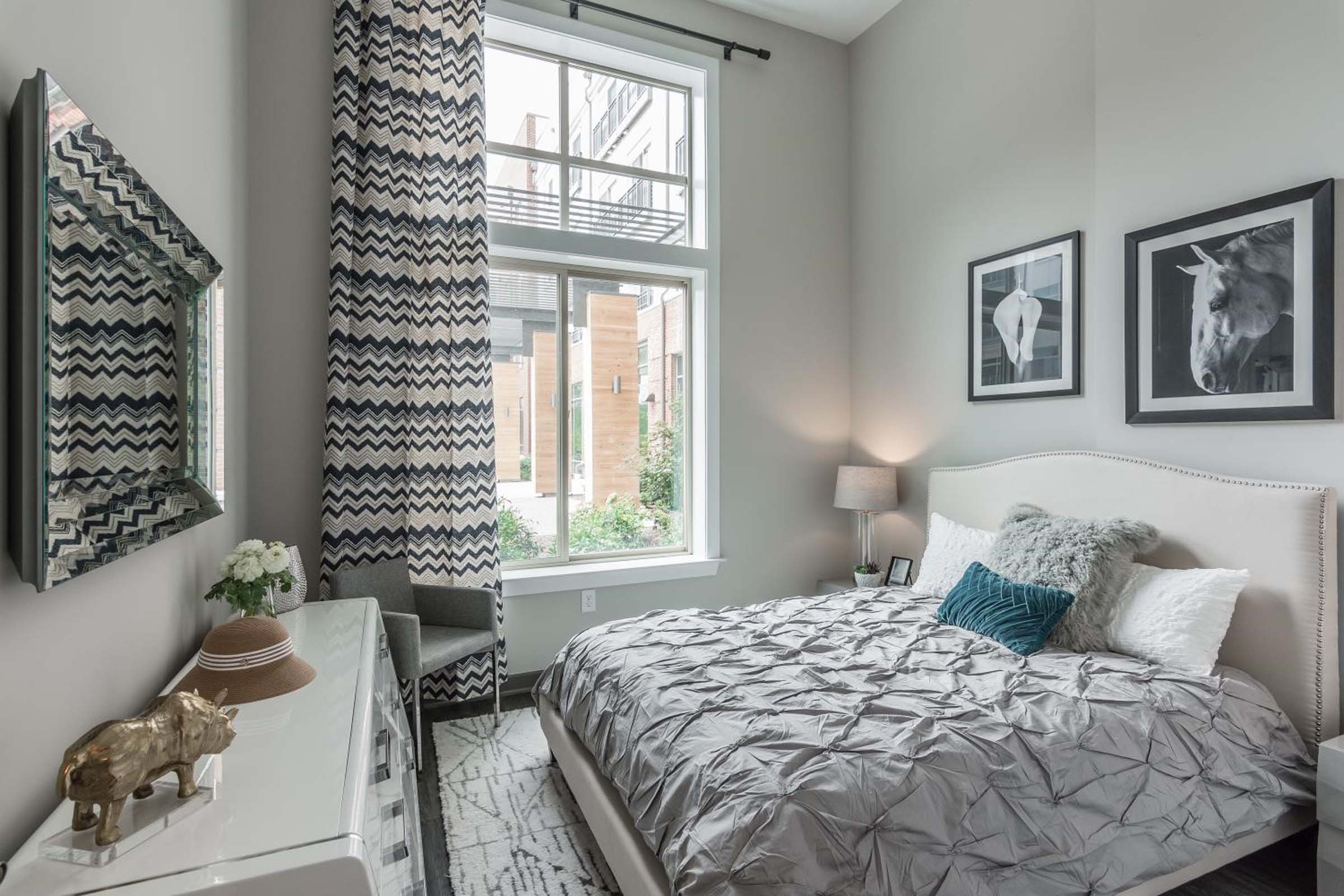 Bedroom with wood-inspired plank flooring and high ceilings