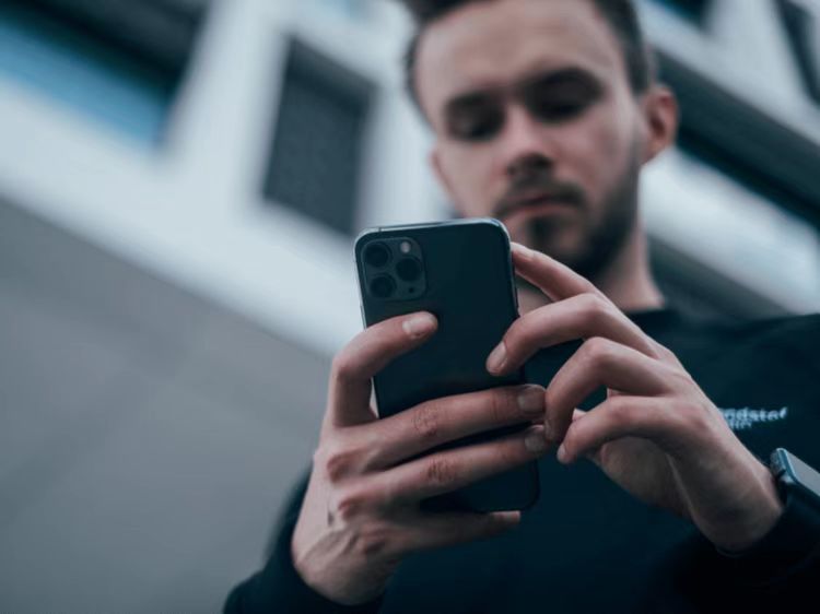 A young man holding a smartphone