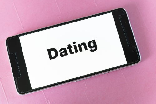 Phone screen with the word "dating" on it