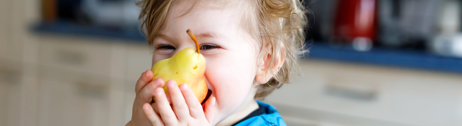 Toddler eating pear 