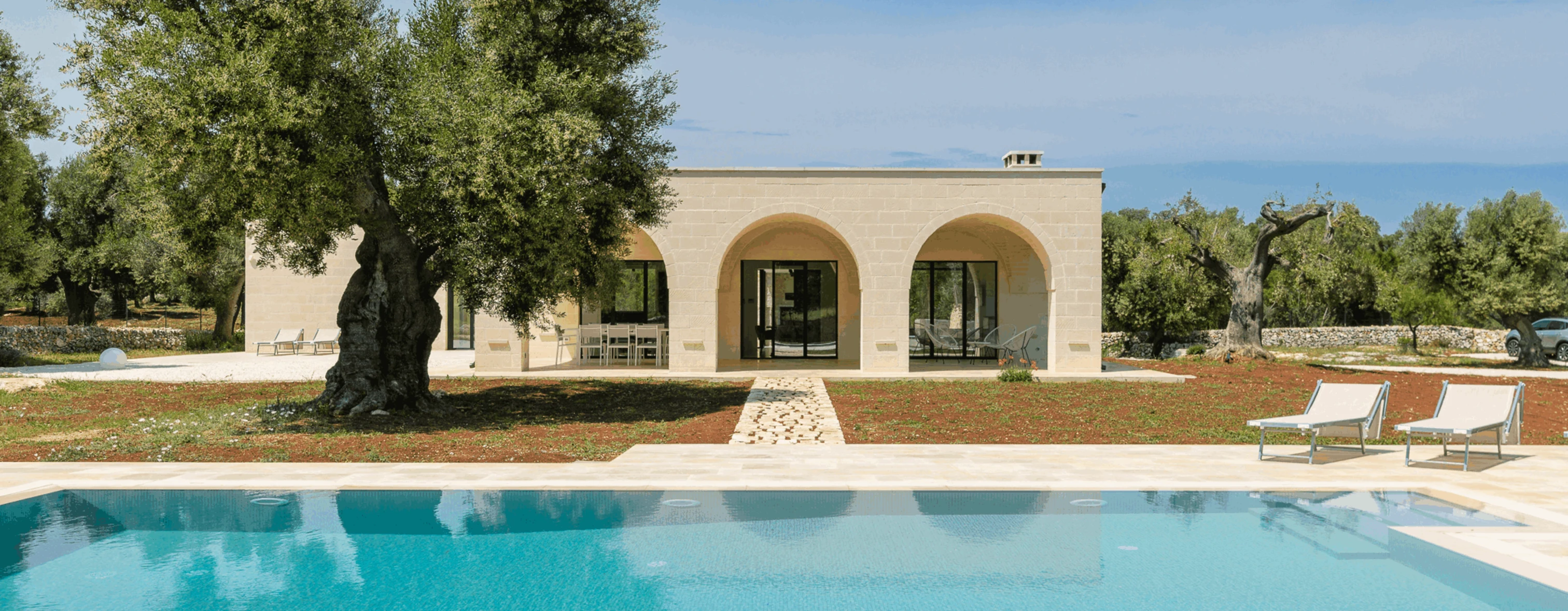 View of Trullo Cillini, a villa in Carovigno managed by Wonderful Italy, from the outside with swimming pool.