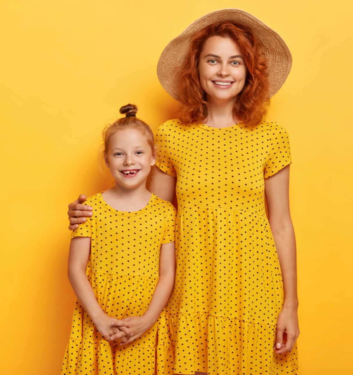 Mom and daughter in matching matching yellow dress (top block)